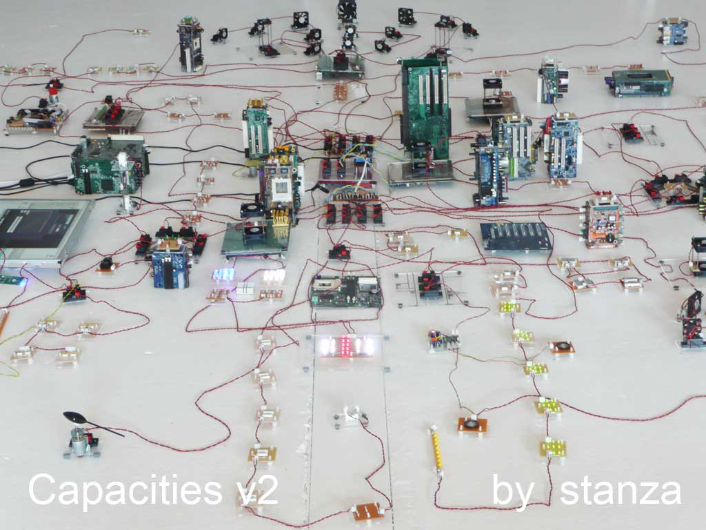 Capacities by Stanza. The installation is about the real time city, making artworks using live data.Essentially this artwork gathers data from the city this is then made virtual and then this virtual city is represented as this electronic city. A manipulation of data, that &lsquo;powers&rsquo; all the &lsquo;events&rsquo; in the installation.The changing data affects all the changes one experiences in the space. ie the moving objects, fans&nbsp;and changing&nbsp;lights are all responding to changes in temperature, light, pressure, noise, and&nbsp;the sound of the space.