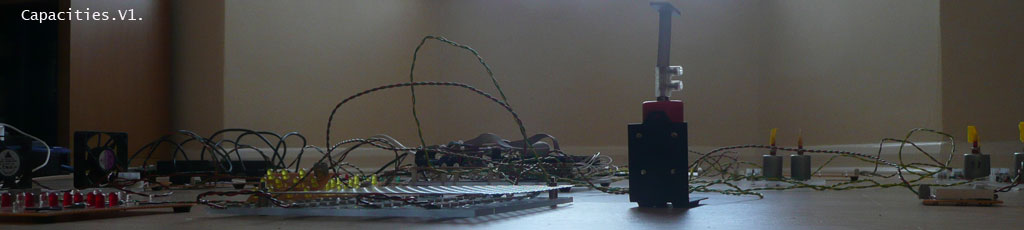 Capacities by Stanza. The installation is about the real time city, making artworks using live data.Essentially this artwork gathers data from the city this is then made virtual and then this virtual city is represented as this electronic city. A manipulation of data, that &lsquo;powers&rsquo; all the &lsquo;events&rsquo; in the installation.The changing data affects all the changes one experiences in the space. ie the moving objects, fans&nbsp;and changing&nbsp;lights are all responding to changes in temperature, light, pressure, noise, and&nbsp;the sound of the space.The real world is made virtual and the virtual is made real again and exposed in the process. 